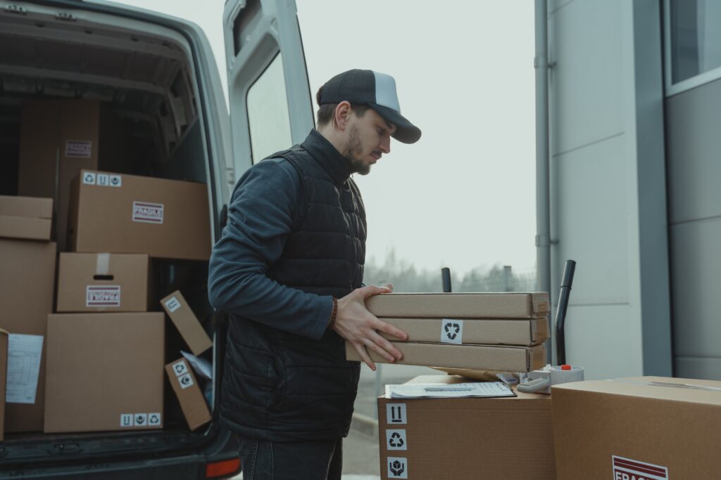 Man-Checking-the-Paper-while-Carrying-the-Packages